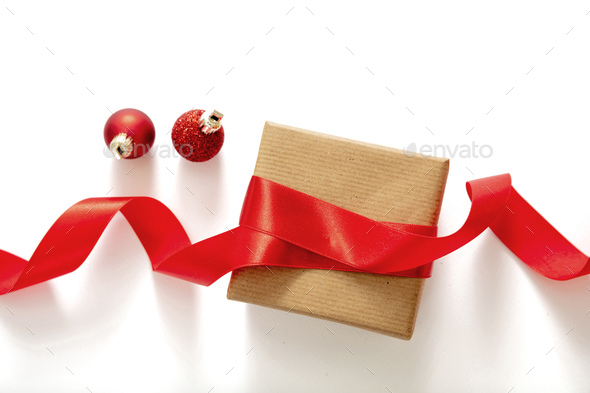 Christmas gift box and red silk ribbon on white background, top