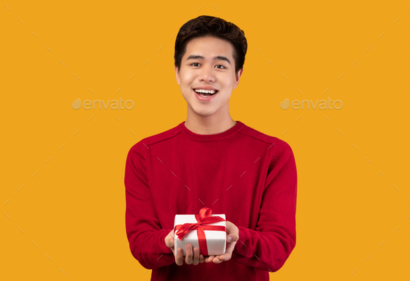 Happy Asian Man Giving Gift Box To His Mother For Mother's Day Celebration.  Stock Photo, Picture and Royalty Free Image. Image 128548402.