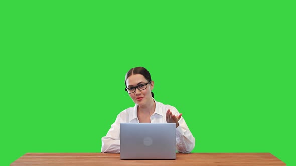 Business Woman Talking on Camera Presenting Something and Closing Laptop in the End on a Green alt