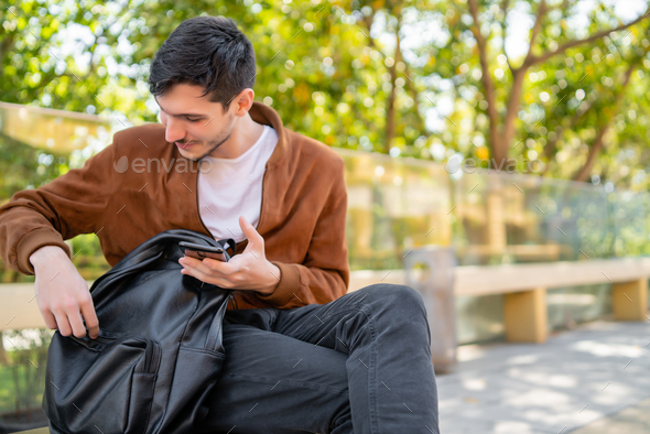 Young man using his phone outdoors.