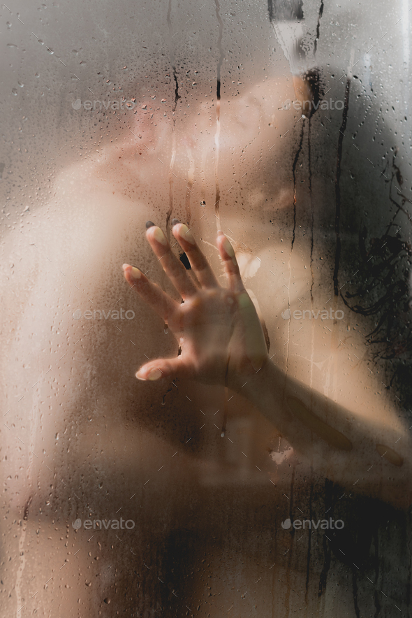 selective focus of couple hugging and in shower Stock Photo by