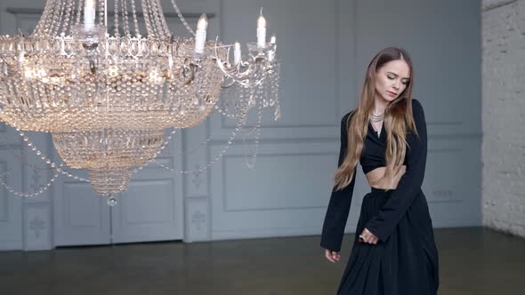 Romantic Woman in Room with Luxury Shiny Chandelier Mysterious and Dramatic Mood alt