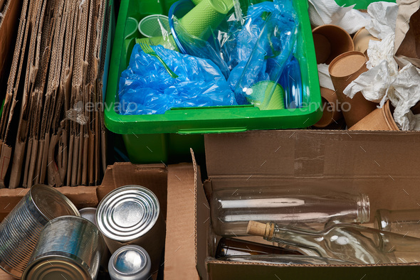 sorted trash of cardboard, glass and plastic bottles, polyethylene, cups, paper, iron cans