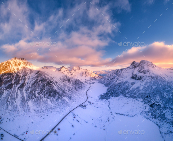 Beautiful snowy mountains in winter at sunset. Aerial view - Stock Photo - Images