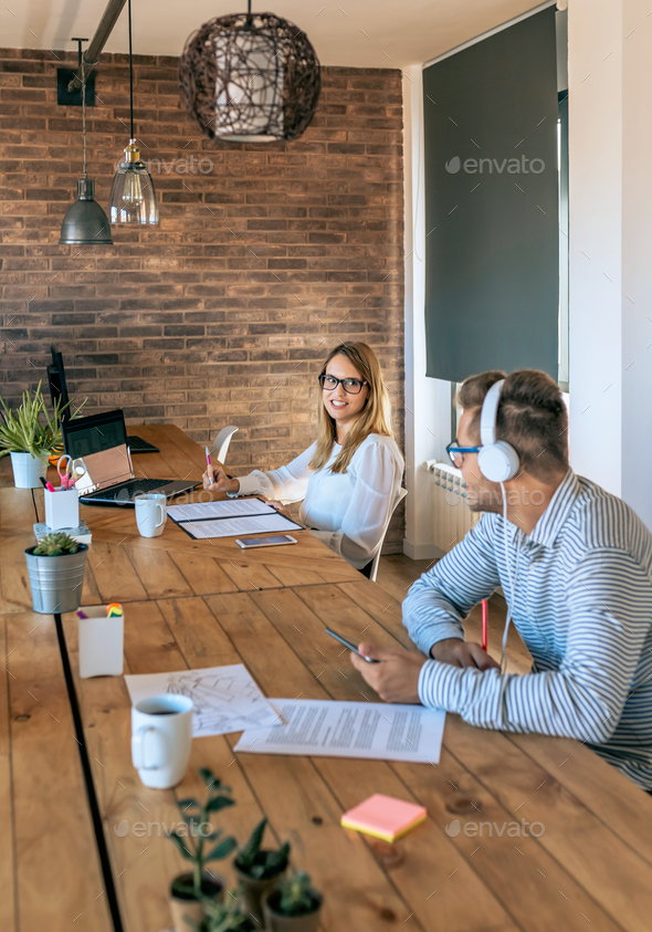 Coworkers talking in a coworking office - Stock Photo - Images