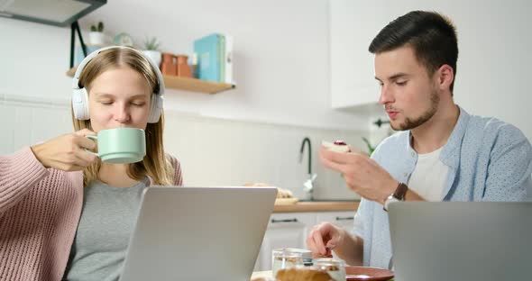 Lady Talks Online By Video Call. Couple Work on Laptop in Kitchen in Home Office alt