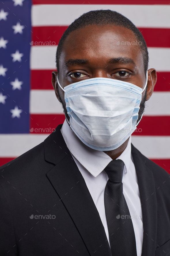 Successful African Man Wearing Mask against American Flag