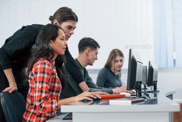 Am I doing it right. Group of young people in casual clothes working in the modern office