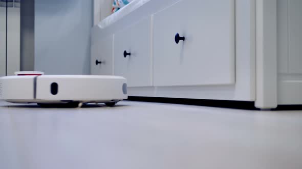 Robot Vacuum Reaches Under Drawers When Cleaning the Floor in a Smart Home alt