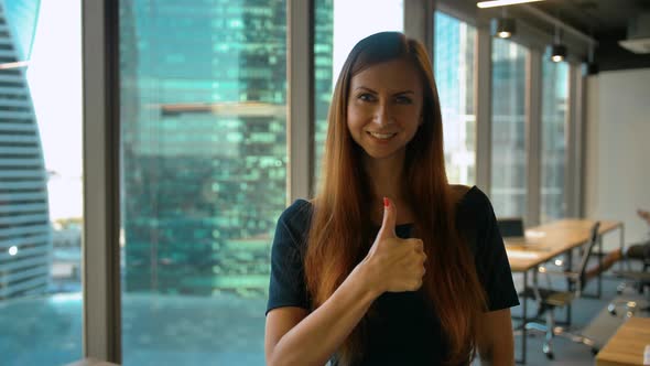 Get Like. Optimistic Businesswoman Makes Hand Gestures Thumb Up Sign in Office alt