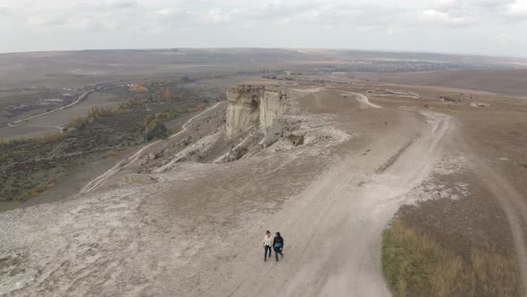 Romantic Couple Walking on Mountain Plateau and Field Plain on Background alt
