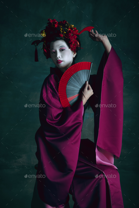 Young japanese woman as geisha on dark green background. Retro style, comparison of eras concept