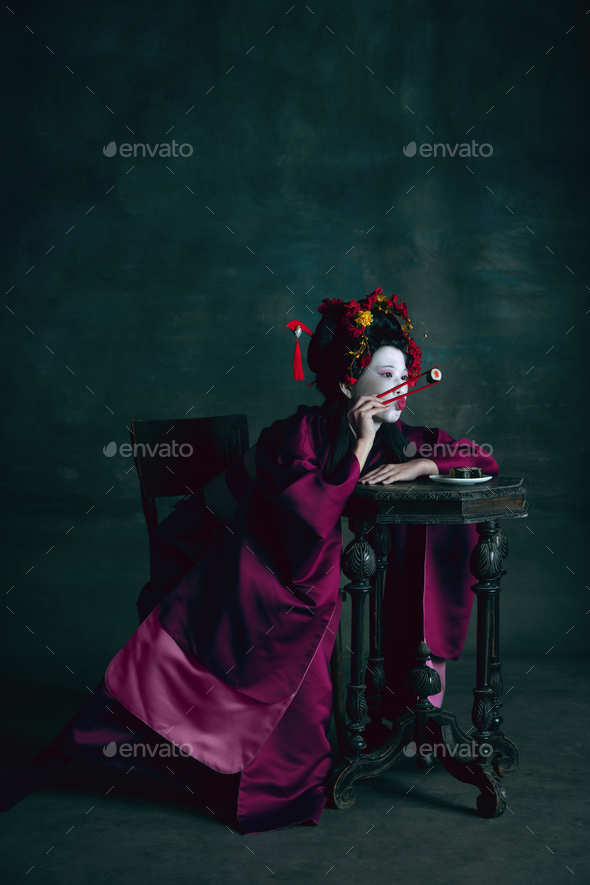 Young japanese woman as geisha on dark green background. Retro style, comparison of eras concept - Stock Photo - Images