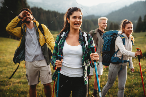 Group of happy fit friends hiking, trekking outdoor nature Stock by nd3000