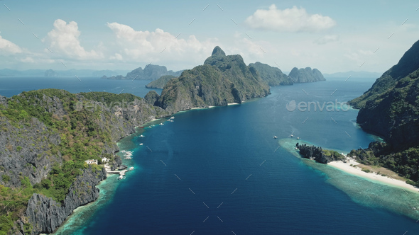 Aerial view of mount island at tropic sea coast. Panorama blue water of ocean bay with green jungle