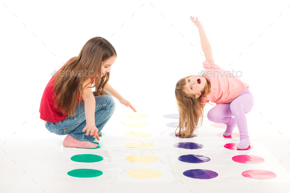 Two happy girls play Twister game