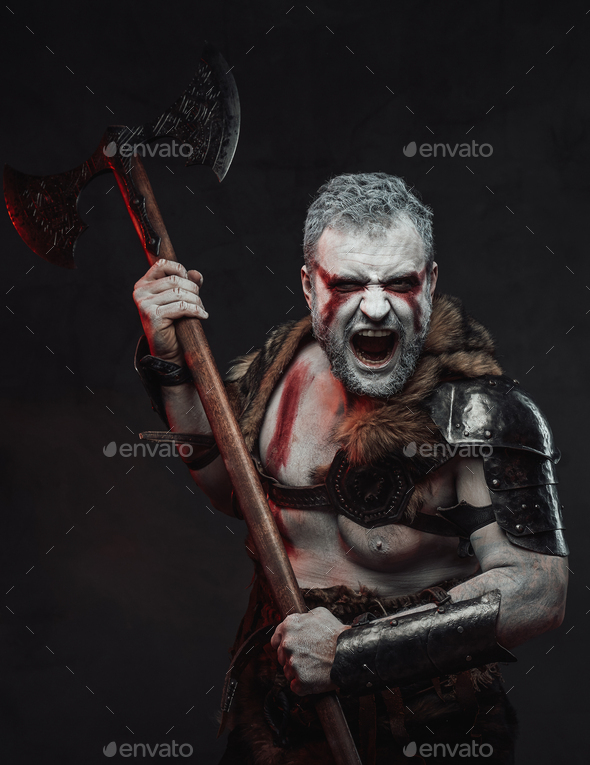 Atmospheric portrait of medieval fighter with axe in studio Stock Photo ...