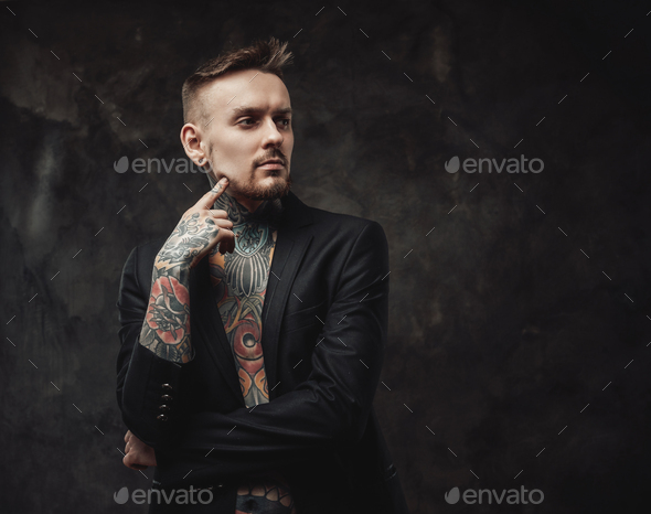 Cheerful hipster person dressed in black jacket in dark background