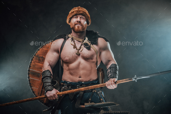 Smiley viking with hat and spear in dark and smokey background Stock ...