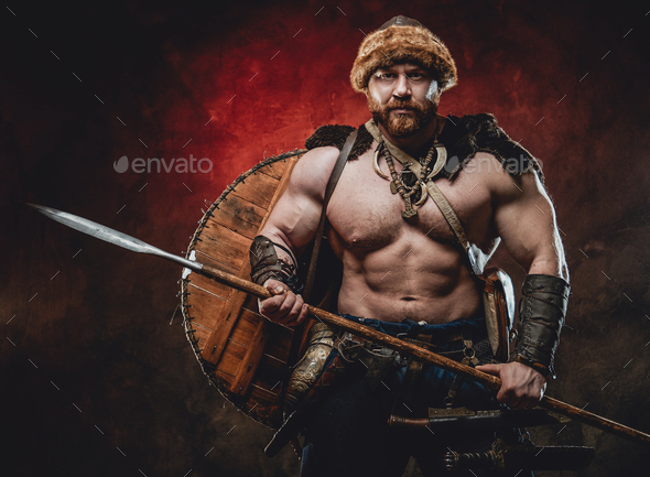 Strong and shirtless viking with spear in dark red background Stock ...