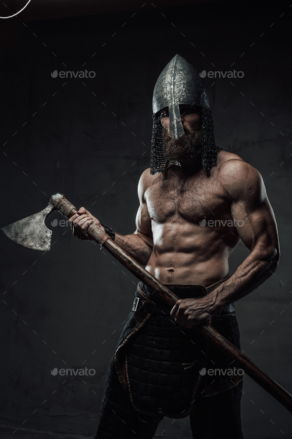 Nord warrior posing with his axe in dark background Stock Photo by fxquadro