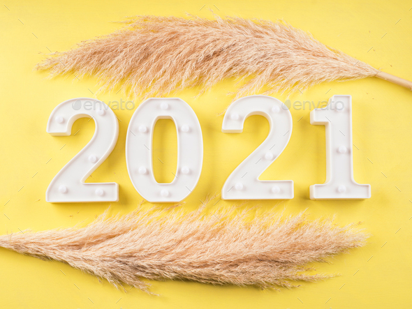 2021 New year numbers on yellow background Stock Photo by tenkende
