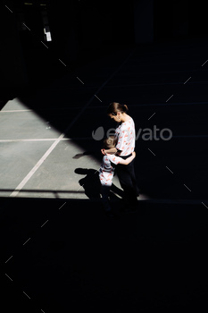 Mother and his boy embracing. Urban photography.