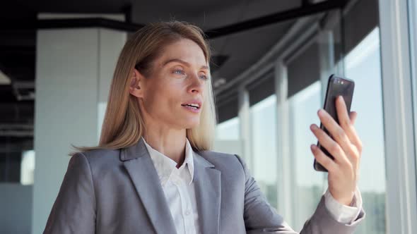 Positive Business Woman Having Video Call on Smartphone Indoor alt