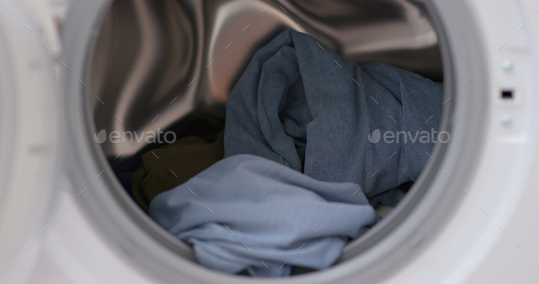 Load clothes to washer machine - Stock Photo - Images