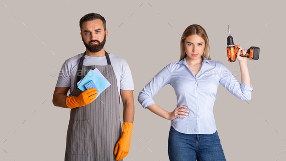 Gender stereotypes and non female profession. Serious man in apron and rubber gloves holding sponges