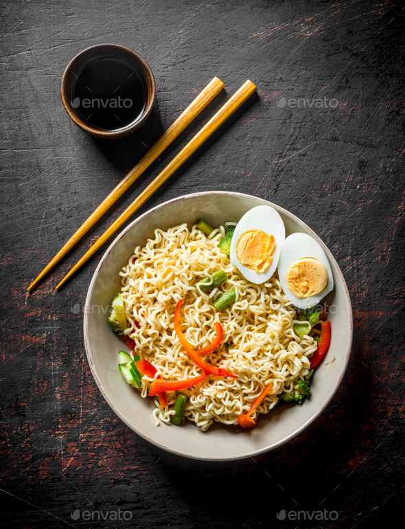 Instant noodles with egg, vegetables and soy sauce. Stock Photo by