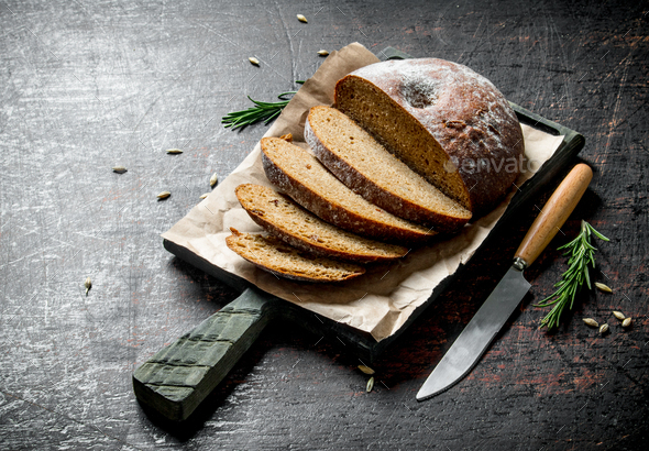 Sliced Bread On A Cutting Board With A Knife And Rosemary Stock Photo By Olesyash