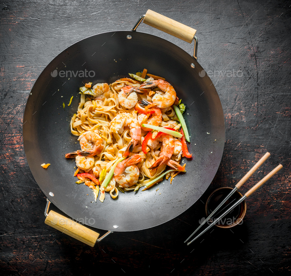 Chinese wok. Udon noodles in a wok pan with chopsticks and soy sauce ...