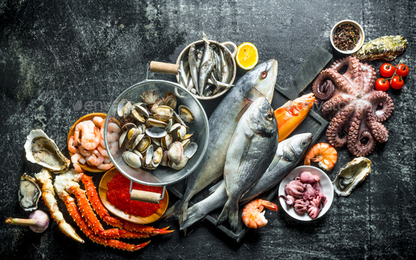 Fresh seafood. Fish, crab, octopus, oysters, shrimp and caviar. Stock Photo by olesyaSh