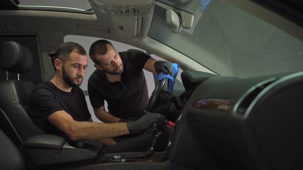 Washing the Body with Brushes Near the Cracks Car Wash Car Two Workers in Black alt