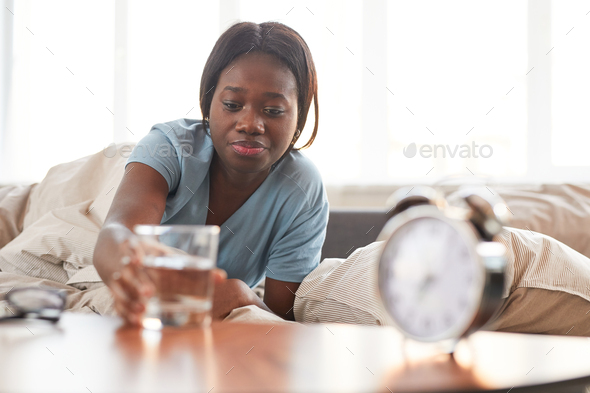 Young African-American Woman Drinking Water in Morning