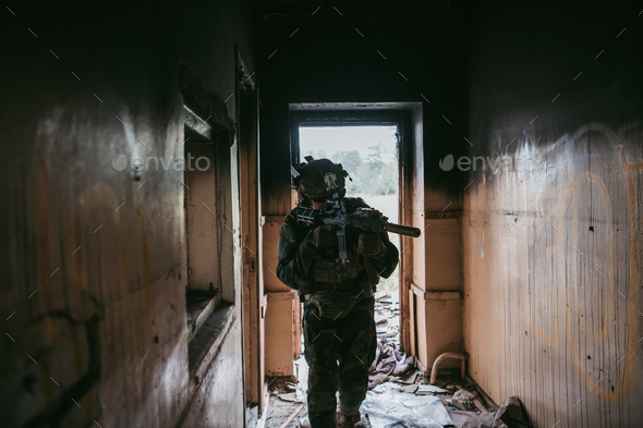 Soldier in combat. Urban combat training, soldier entering abandoned building. Anti terrorist - Stock Photo - Images