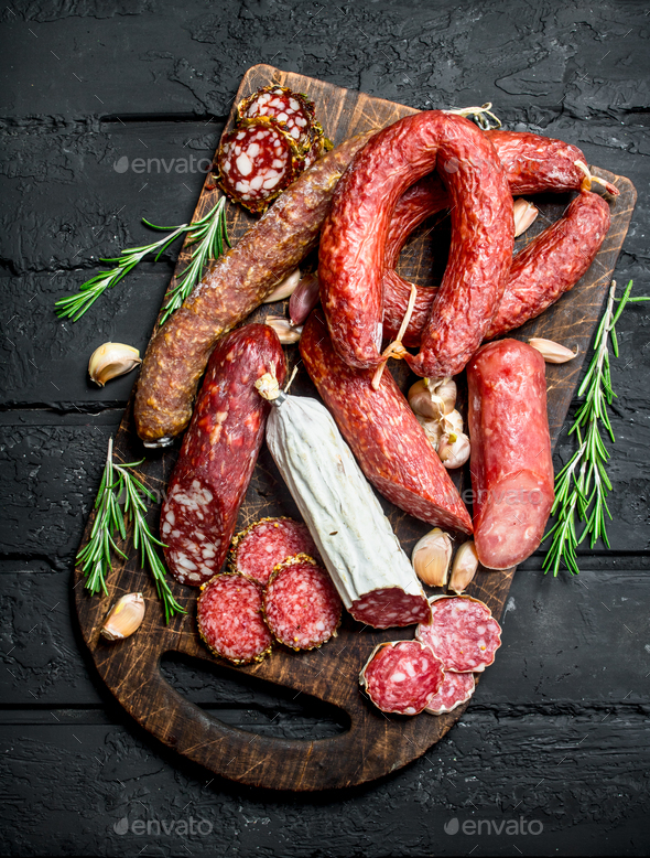 Different types of salami with spices and herbs. Stock Photo by Artem_ka2