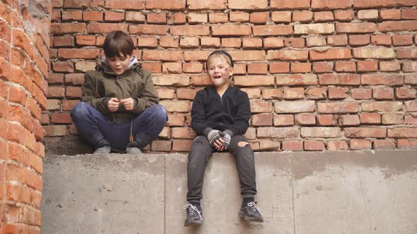 Hungry Street Boys Looking for Food Outdoors Wearing Dirty Clothes alt