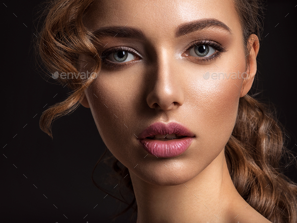 Beautiful woman with sexy face looks at camera. Stock Photo by valuavitaly
