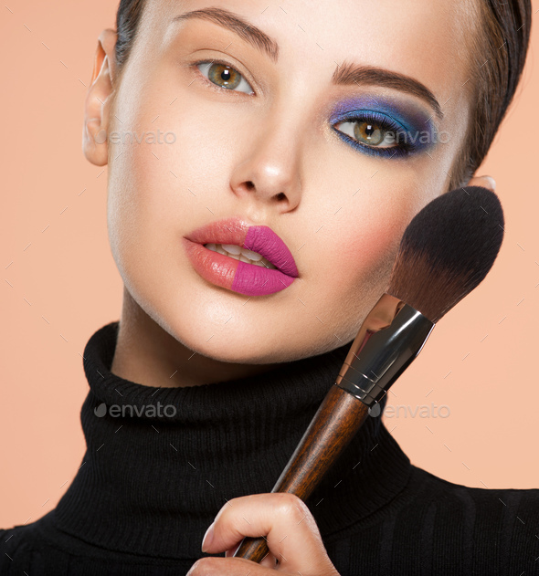 One half face of a beautiful white woman with bright makeup and the other  is natural. Stock Photo by valuavitaly