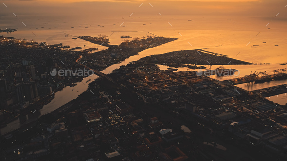 Sunset over sea bay at pier city aerial. Tropic cityscape on river banks at summer sun set light - Stock Photo - Images