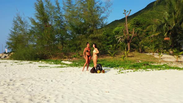 Ladies enjoying life on perfect resort beach journey by clear sea with white sand background of Thai alt