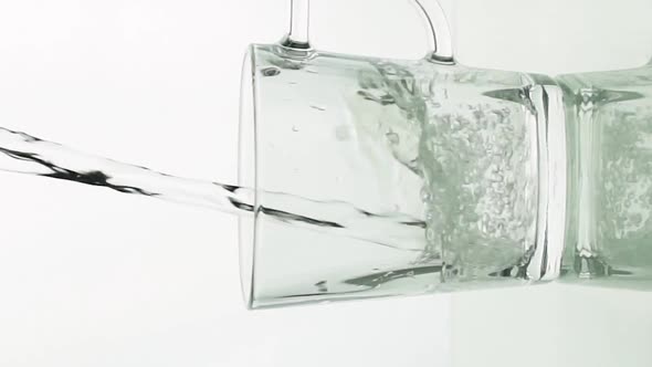 Vertical Video Crystal Clear Water Pouring Into Glass Mug