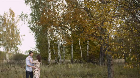 Young Couple Walking on a Meadow alt