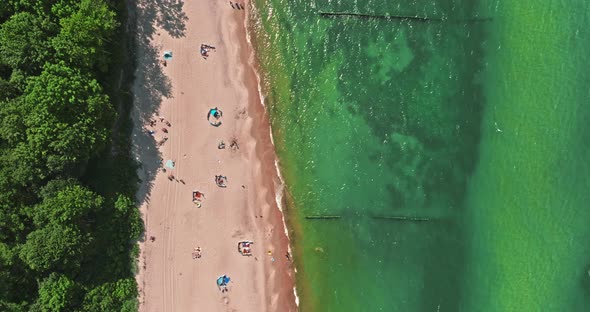 Beach with few people at Baltic Sea in summer. alt