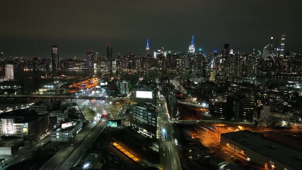 An aerial view from over Long Island City, New York at night. The drone