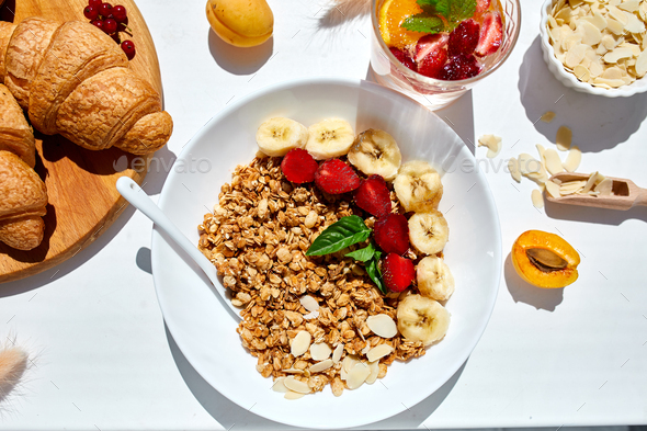 Healthy breakfast bowl on white table in hard lights