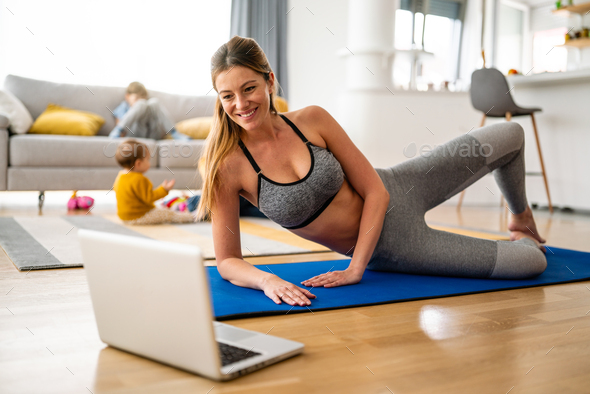 Young woman is exercising yoga at home. Fitness, workout, healthy living and diet concept