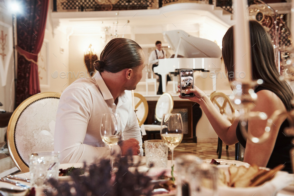 Beautiful couple have romantic dinner in luxury restaurant at evening time